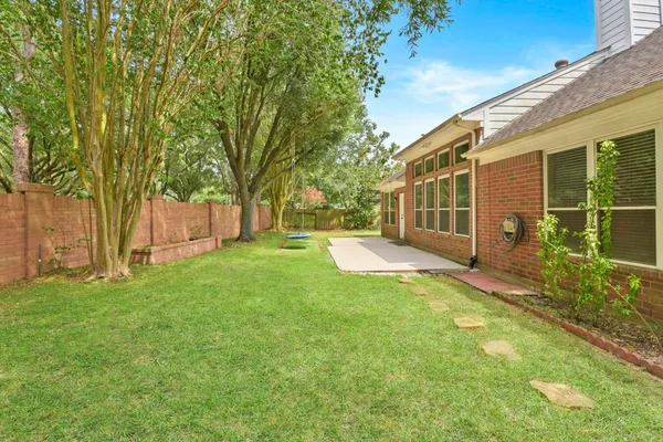 a view of a house with backyard and sitting area