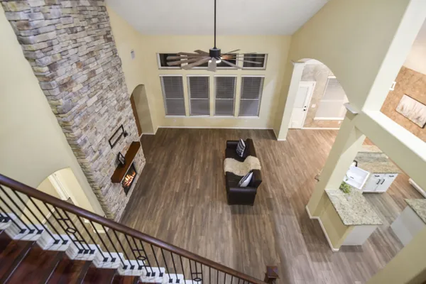 a view of a living room with furniture and wooden floor