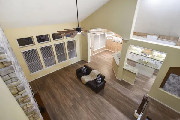 a living room with wooden floor and furniture