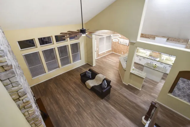 a living room with wooden floor and furniture