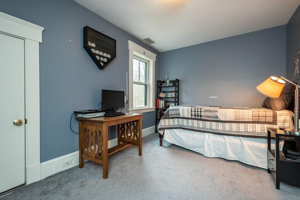 25 Crockett Road Upton, MA 01568 - Photo 30 of 39 a bedroom with furniture and a flat screen tv