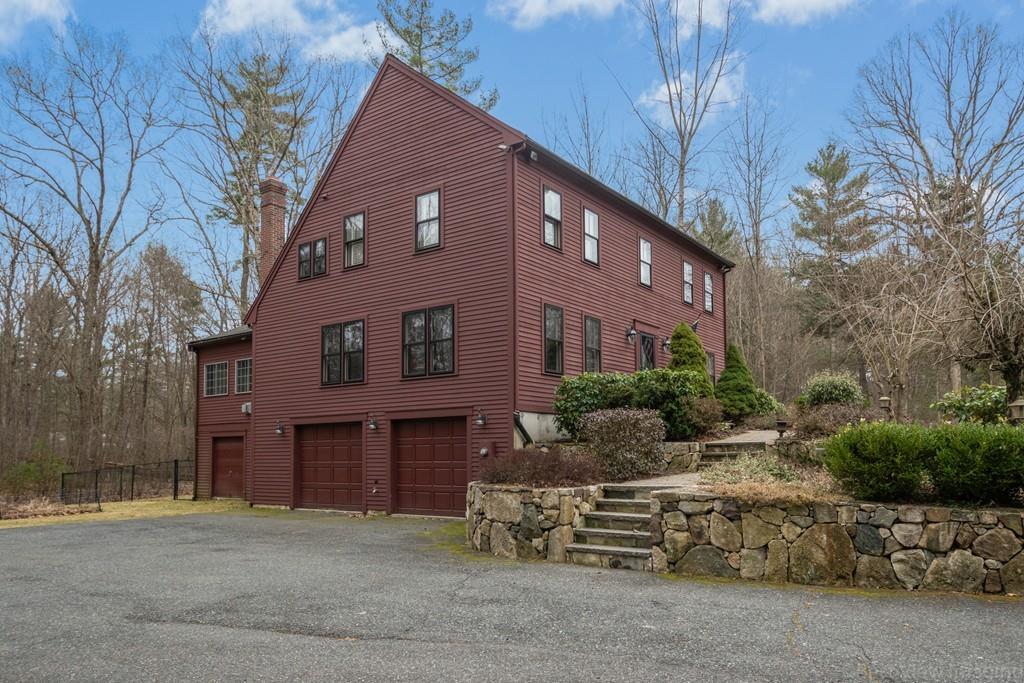 25 Crockett Road Upton, MA 01568 - Photo 3 of 39 a front view of a house with a garden