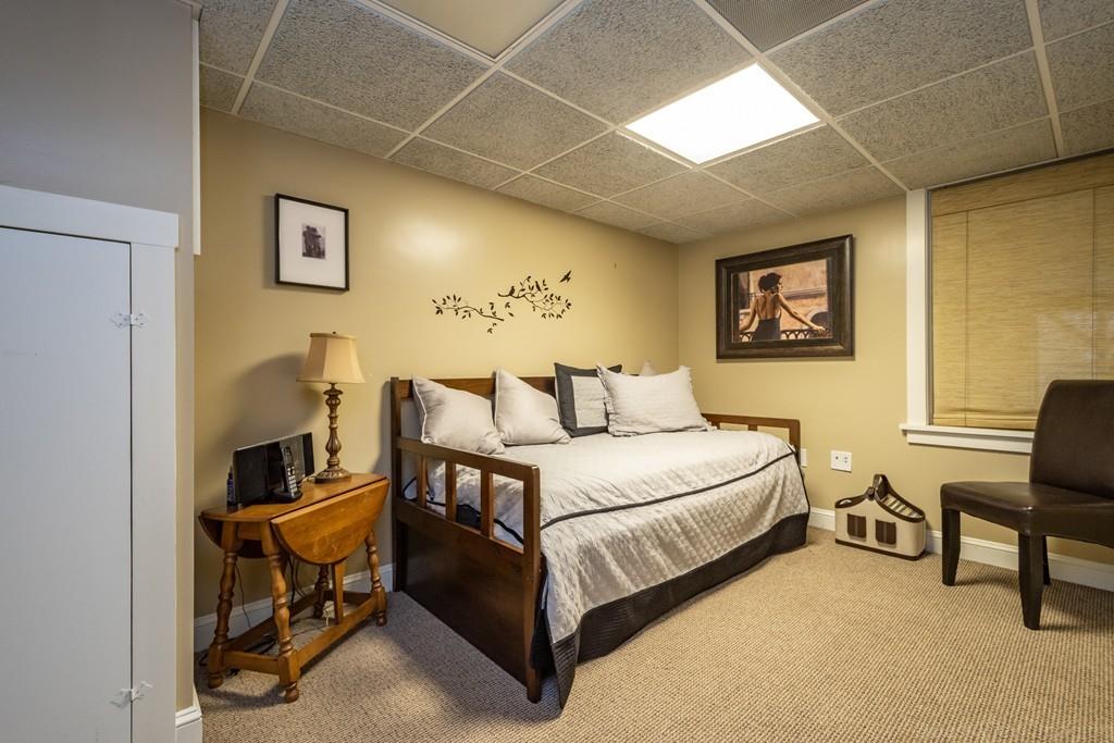 25 Crockett Road Upton, MA 01568 - Photo 38 of 39 a bedroom with a bed and a chair in it