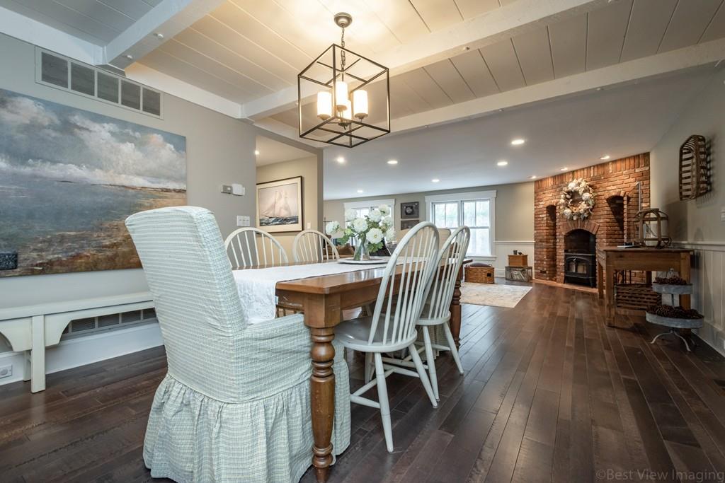 25 Crockett Road Upton, MA 01568 - Photo 9 of 39 a dining room with wooden floor a chandelier a wooden table and chairs
