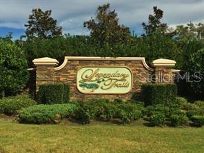 a view of sign board with yard and green space