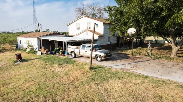 a view of a yard with a tree