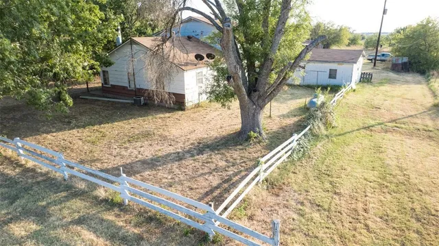 a view of a house with a yard and sitting area