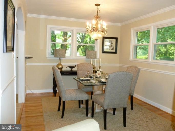 5209 Kipling Street Springfield, VA 22151 - Photo 3 of 29 a view of a dining room with furniture a chandelier and wooden floor