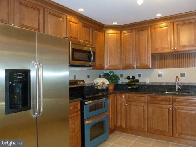 5209 Kipling Street Springfield, VA 22151 - Photo 5 of 29 a kitchen with stainless steel appliances granite countertop a refrigerator a stove a sink and dishwasher