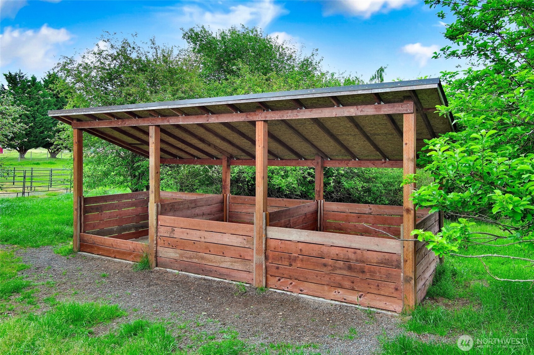 14419 Martinson Road Southeast Yelm, WA 98597 - Photo 28 of 39 a view of a backyard with couches under an umbrella