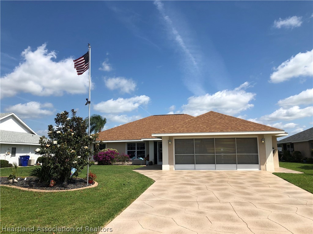 1208 Lakeside Way Sebring, FL 33875 - Photo 1 of 29 a front view of a house with a garden
