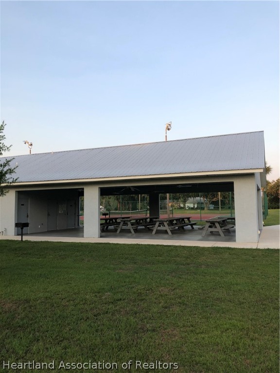 1208 Lakeside Way Sebring, FL 33875 - Photo 28 of 29 a front view of a house with a garden and plants