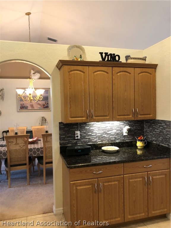 1208 Lakeside Way Sebring, FL 33875 - Photo 6 of 29 a kitchen with granite countertop a sink a stove and cabinets