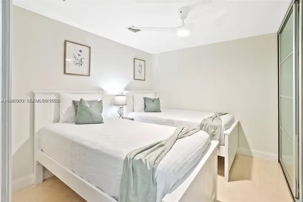 a bedroom with a bed and a lamp