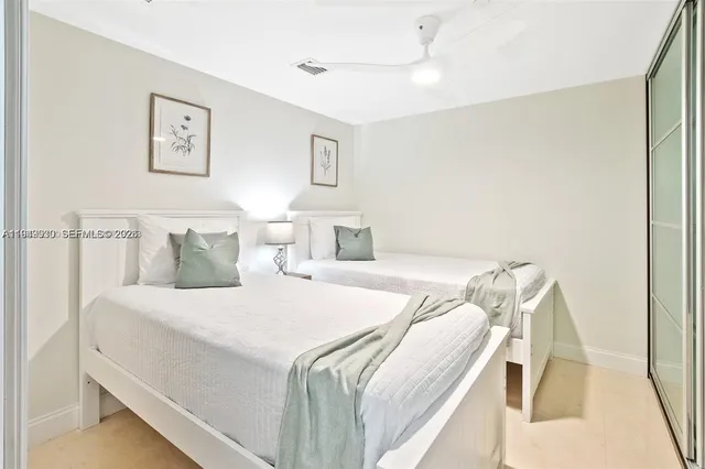 a bedroom with a bed and a lamp