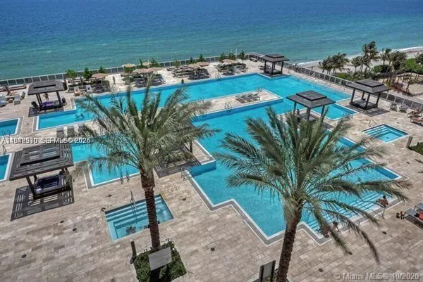 a view of a backyard with plants and ocean view