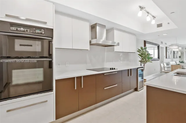 a kitchen with stainless steel appliances granite countertop a stove and a sink
