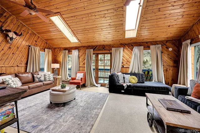 a living room with furniture and large windows