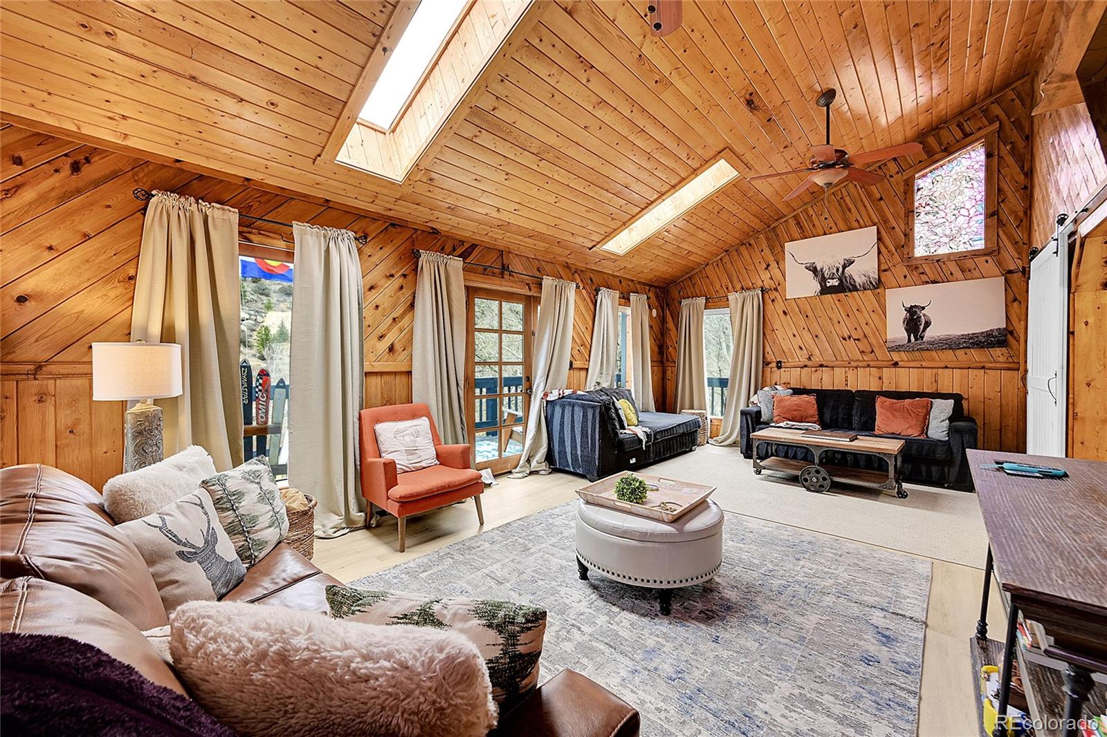 3645 Stanley Road Dumont, CO 80436 - Photo 14 of 40 a living room with furniture a fireplace and a large window