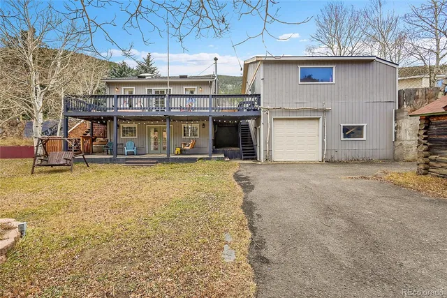an empty room with wooden walls and stairs