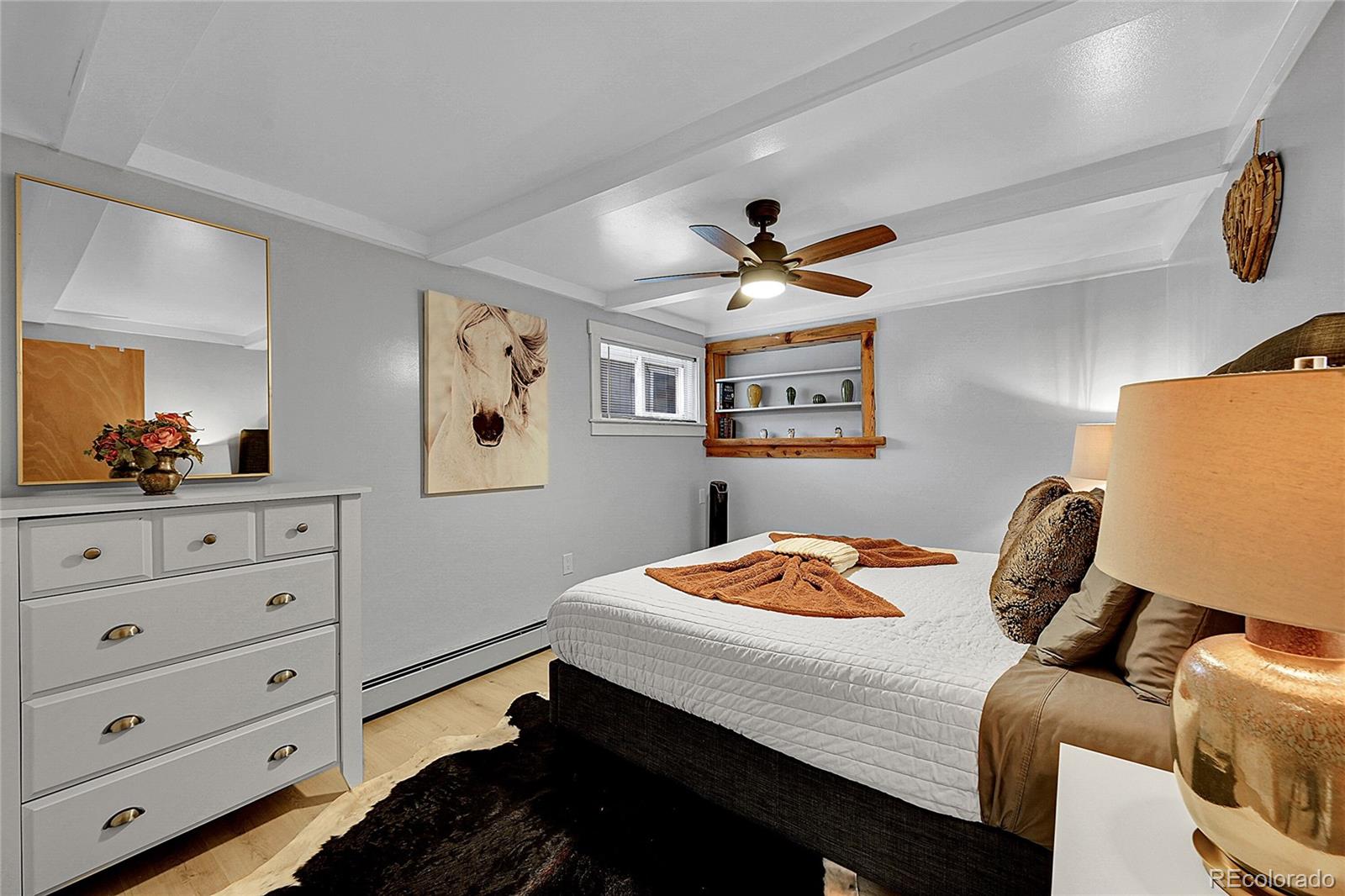 3645 Stanley Road Dumont, CO 80436 - Photo 8 of 39 a bedroom with a bed and a dresser in it
