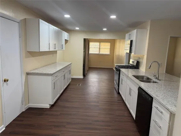 a kitchen with counter top space sink and center