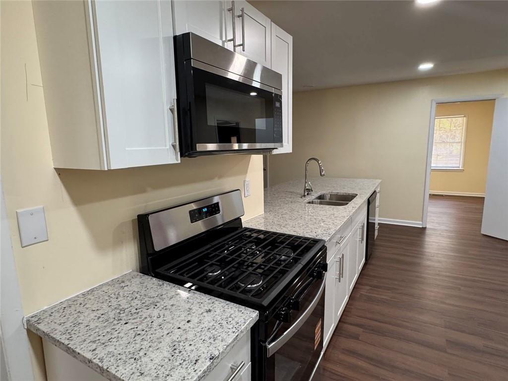 202 Lawn Street Fort Valley, GA 31030 - Photo 7 of 7 a kitchen with a stove and a microwave