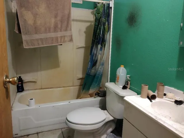 a bedroom with a bed and ceiling fan