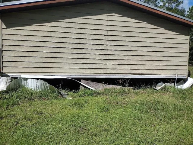 a view of a yard with a car parked in the road