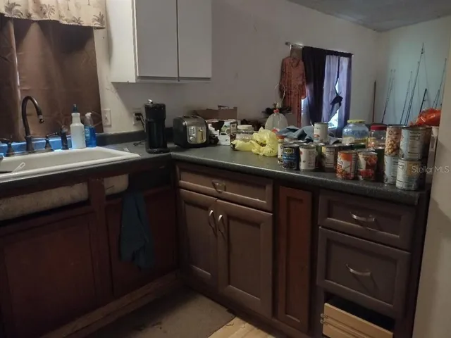a kitchen with sink and cabinets