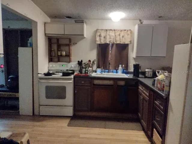 a kitchen with a sink stove and cabinets