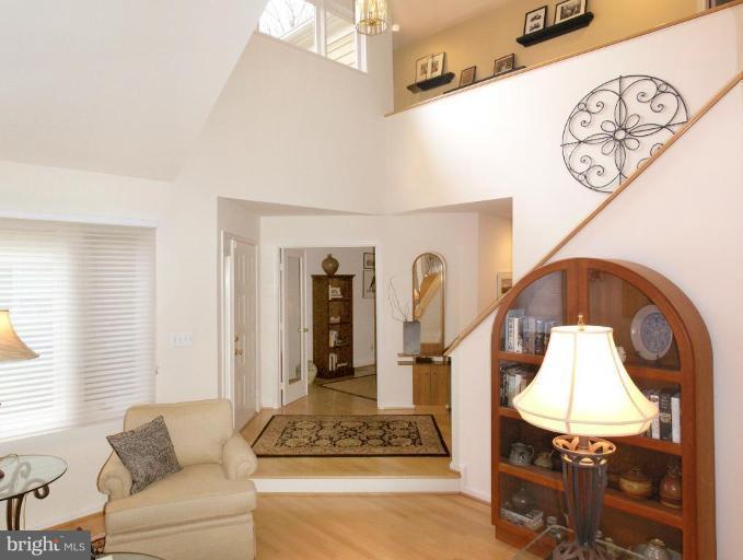 a living room with furniture and a mirror