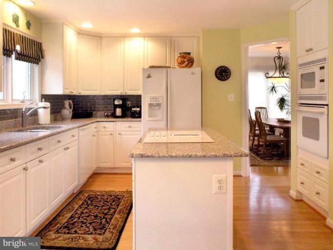 11200 Center Post Court Reston, VA 20194 - Photo 11 of 30 a kitchen with stainless steel appliances kitchen island granite countertop a sink and cabinets