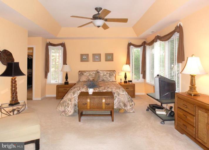 11200 Center Post Court Reston, VA 20194 - Photo 18 of 30 a bedroom with furniture a bed and a chandelier