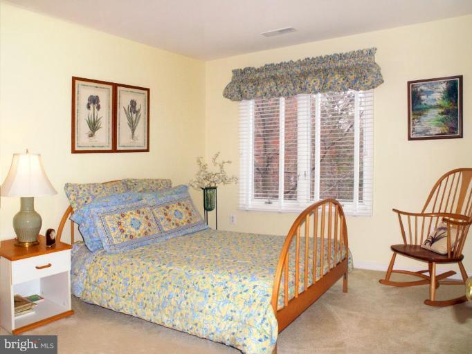 11200 Center Post Court Reston, VA 20194 - Photo 20 of 30 a bedroom with a bed a couch and a window