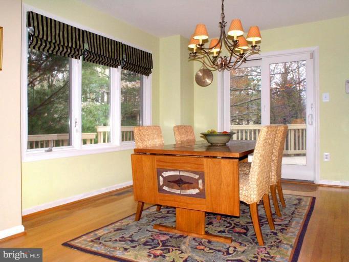 11200 Center Post Court Reston, VA 20194 - Photo 7 of 30 a dining room with chandelier and wooden floor
