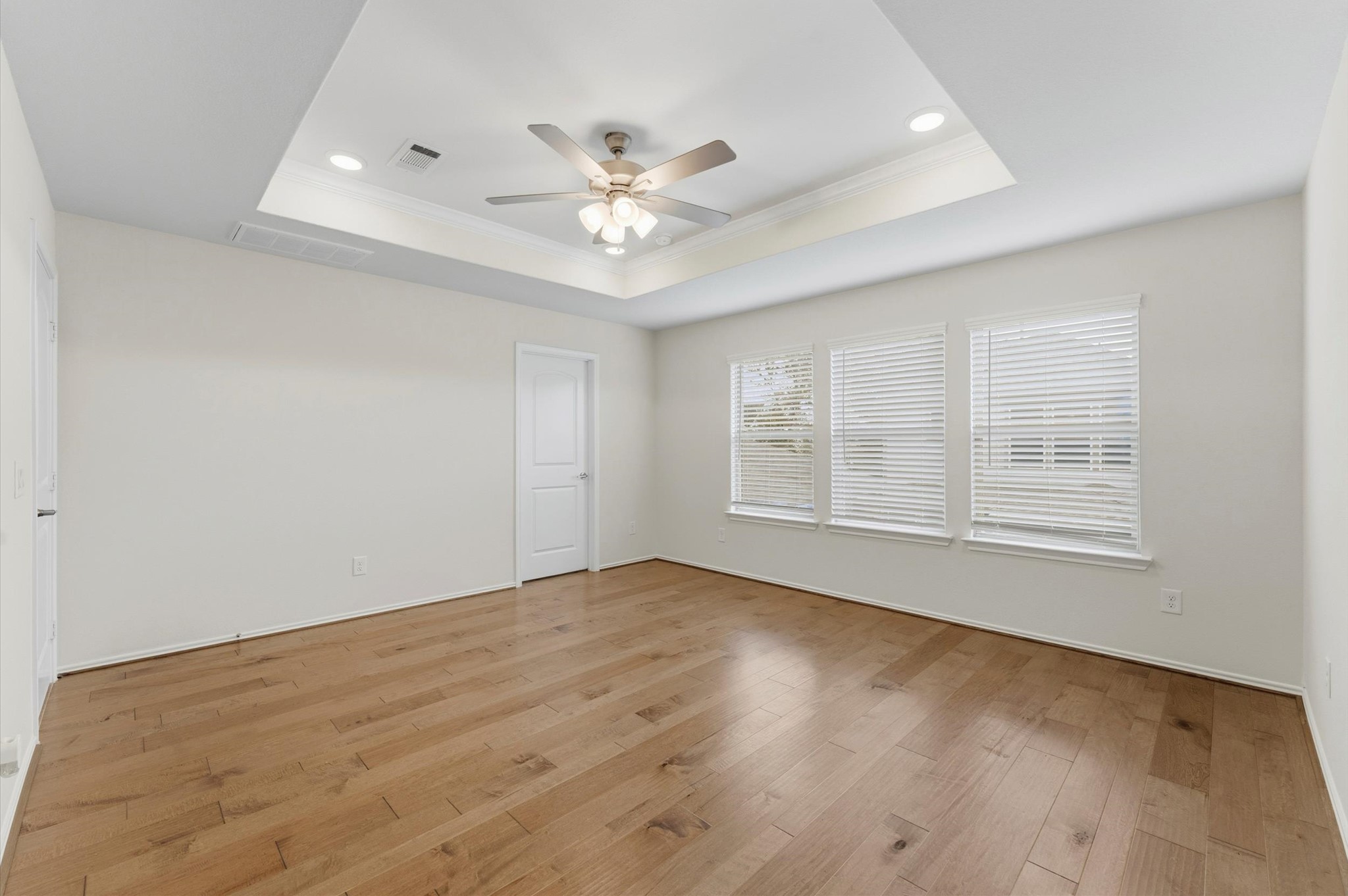 1822 Calabasas Way Houston, TX 77080 - Photo 16 of 32 an empty room with wooden floor fan and windows