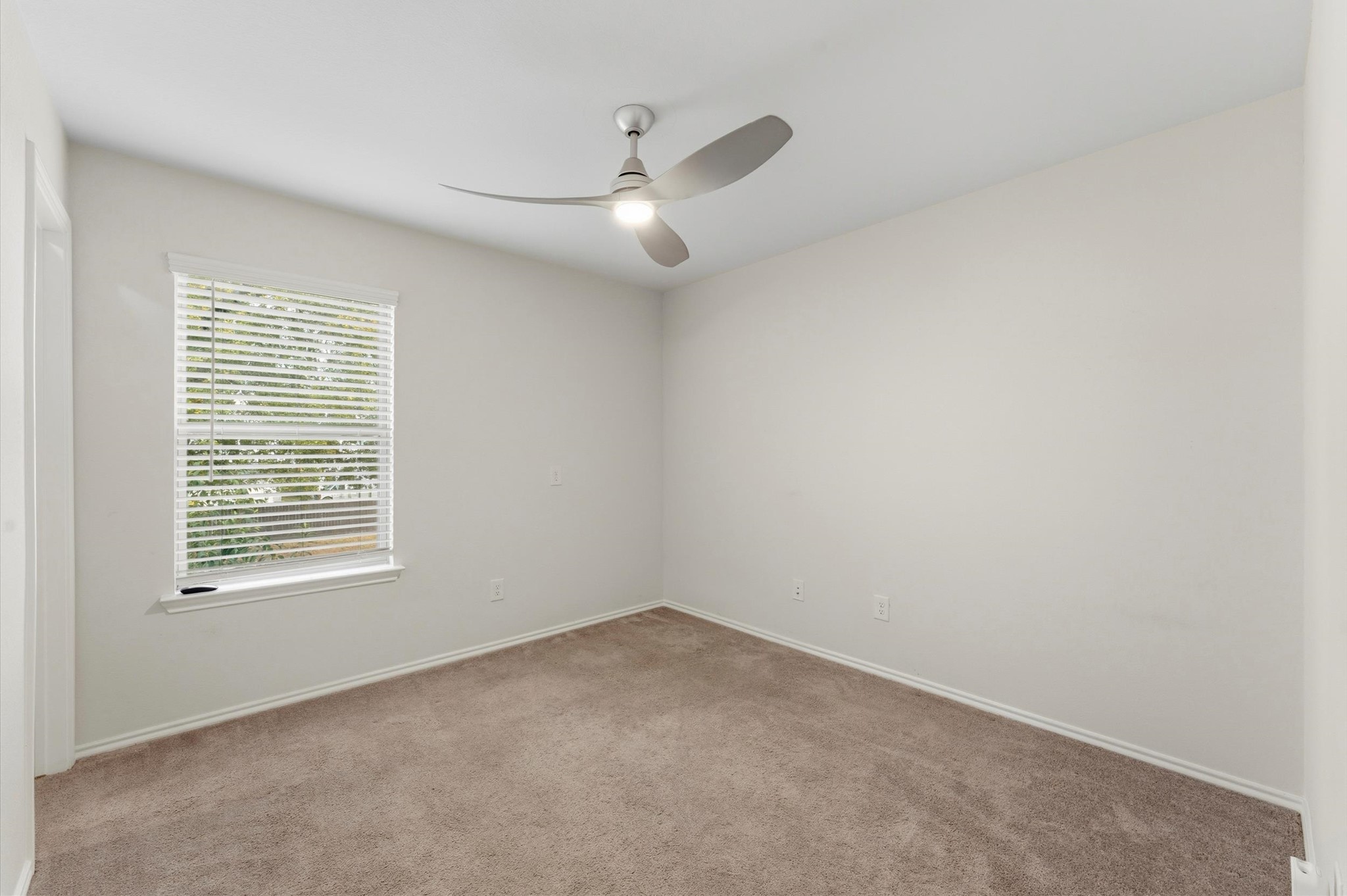 1822 Calabasas Way Houston, TX 77080 - Photo 26 of 32 an empty room with a window and a fan