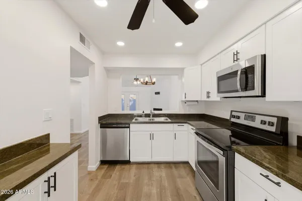 a kitchen with stainless steel appliances a stove microwave and refrigerator