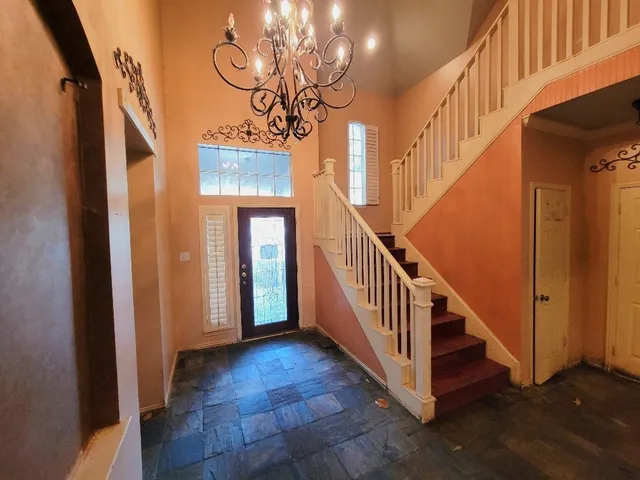 a view of entryway and hall with wooden floor
