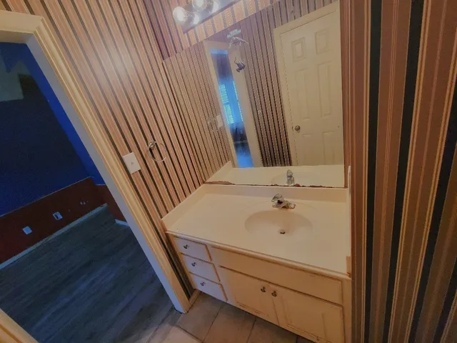 a bathroom with a sink and a mirror
