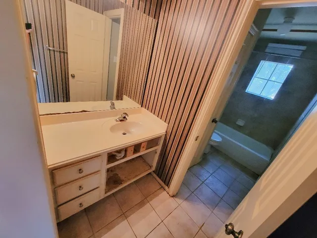 a view of a bathroom with a sink and mirror