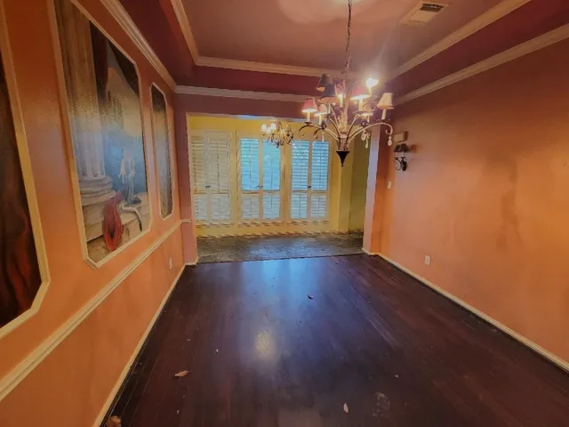 a view of a livingroom with wooden floor and a ceiling fan