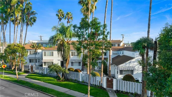 a view of a house with a yard and potted plants