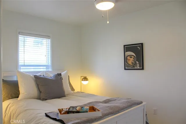 a bedroom with a bed and a lamp