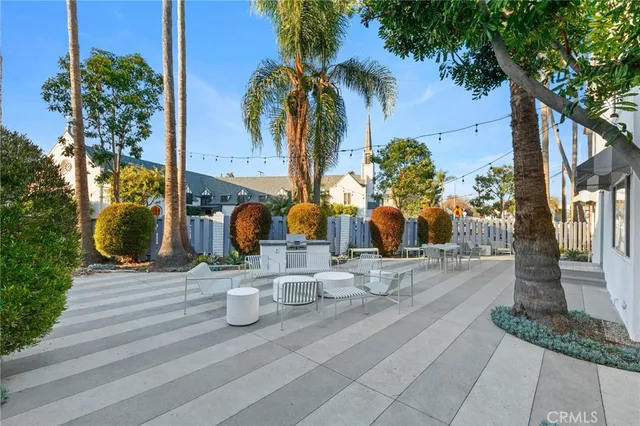 a view of a street with potted plants