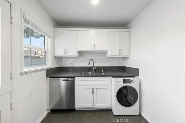 a kitchen with a stove top oven sink