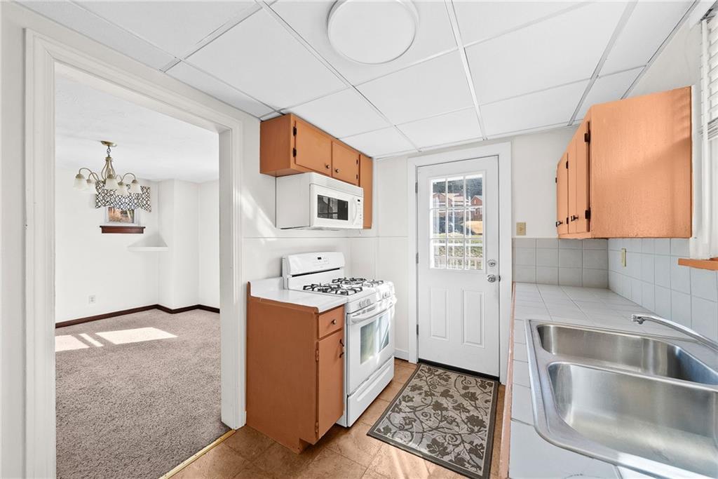 105 Kaplan Avenue Pittsburgh, PA 15227 - Photo 16 of 37 a kitchen with stainless steel appliances granite countertop a refrigerator and a stove