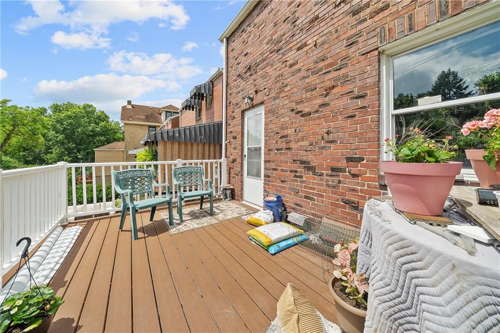 105 Kaplan Avenue Pittsburgh, PA 15227 - Photo 33 of 37 a view of a patio with table and chairs and wooden floor