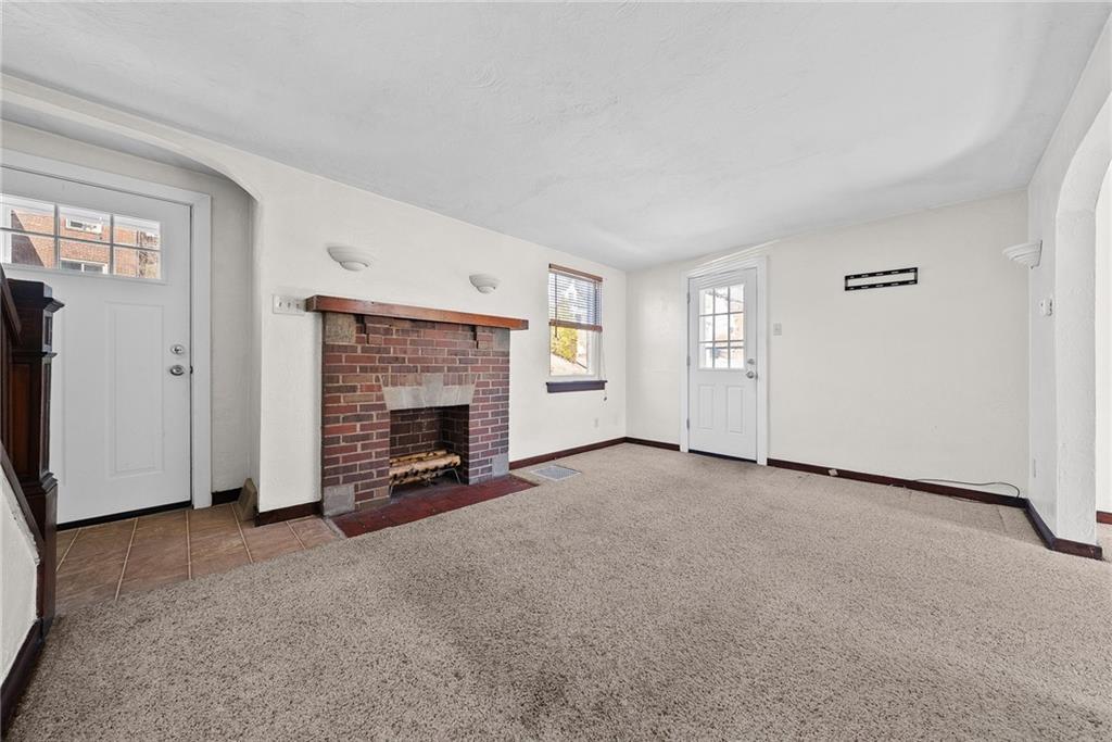 105 Kaplan Avenue Pittsburgh, PA 15227 - Photo 7 of 37 Spacious living room with fireplace and side door to new concrete patio.